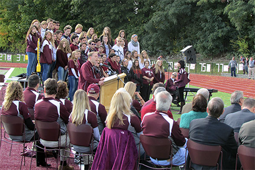 students singing on centennial field