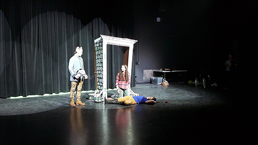 three students performing in the black box theater