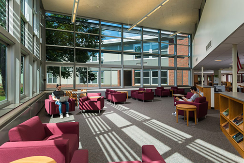 maroon couches in a library common area