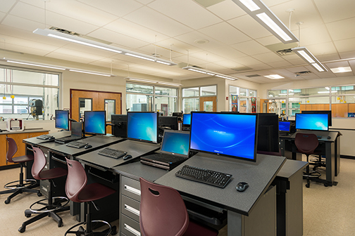 rows of computers on desks in a design lab