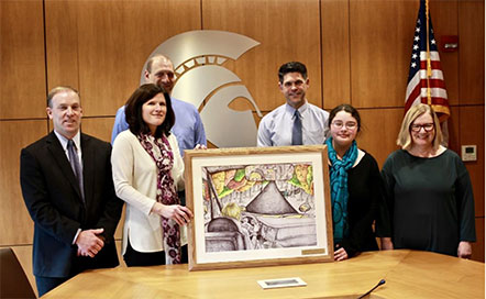 group photo with photo in frame