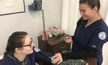 a student taking the blood pressure of another sutdent