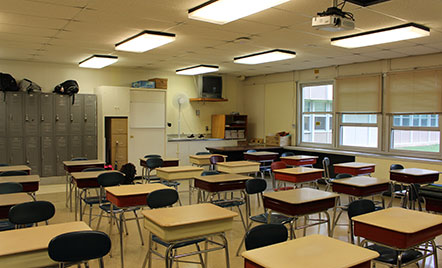 old desks lined up in an outdated classroom