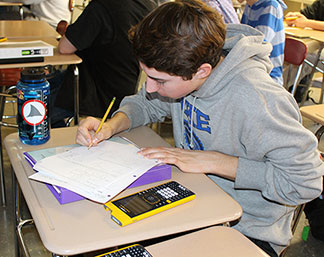 student at a desk doing work