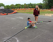 student practicing rowing on pavement