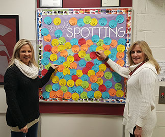 two teachers placing circles on board