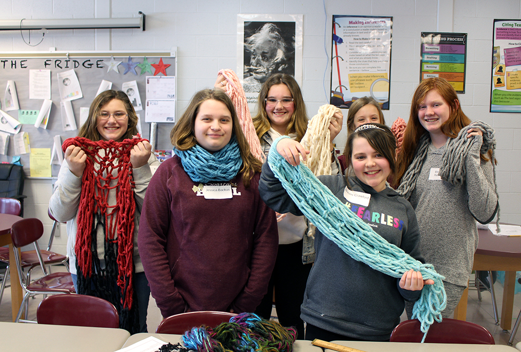 students arm knitting with chunky yarn