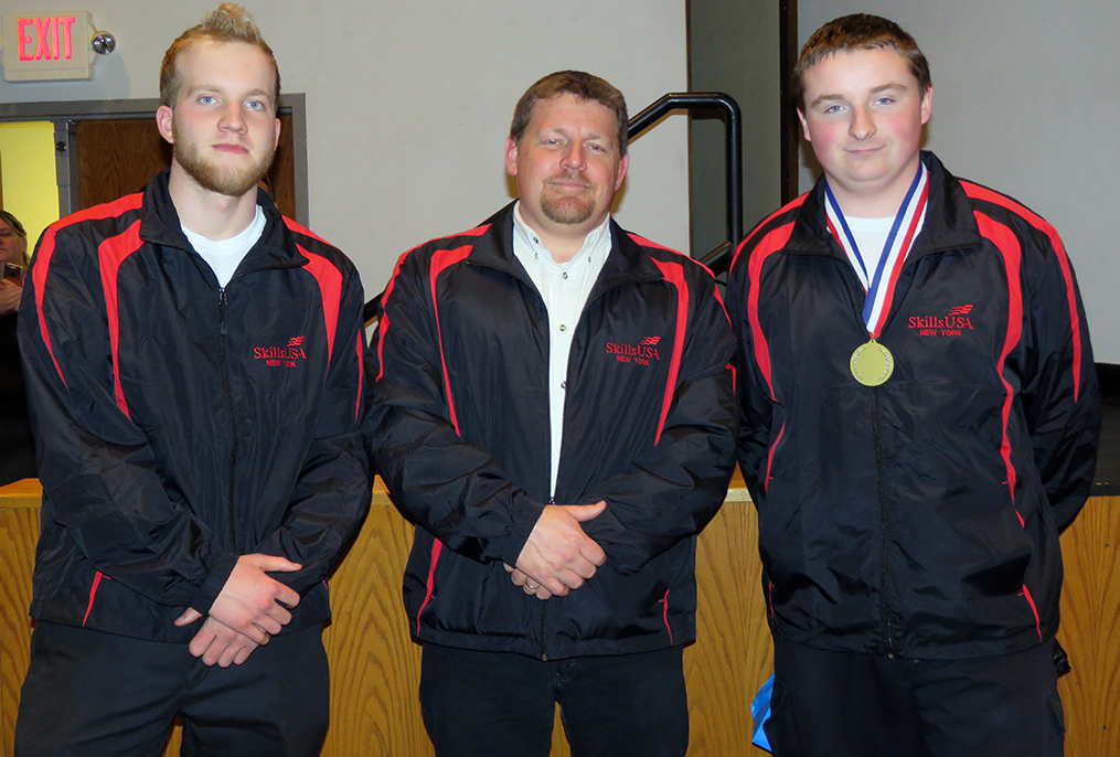 three people wearing skillsUSA jackets standing together