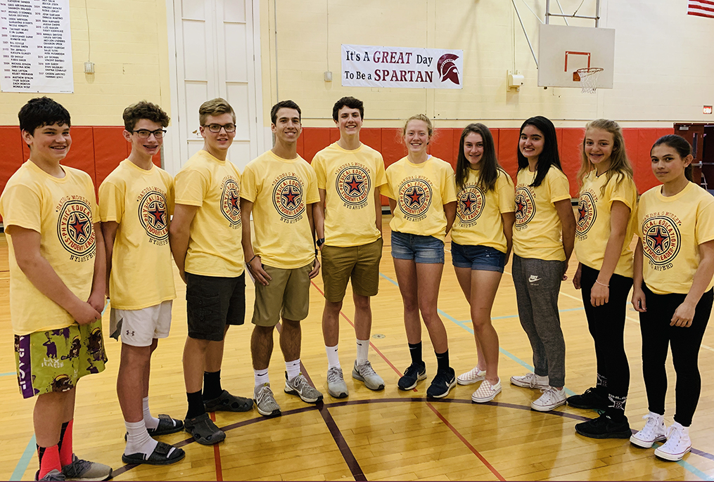 students in yellow shirts standing in a row