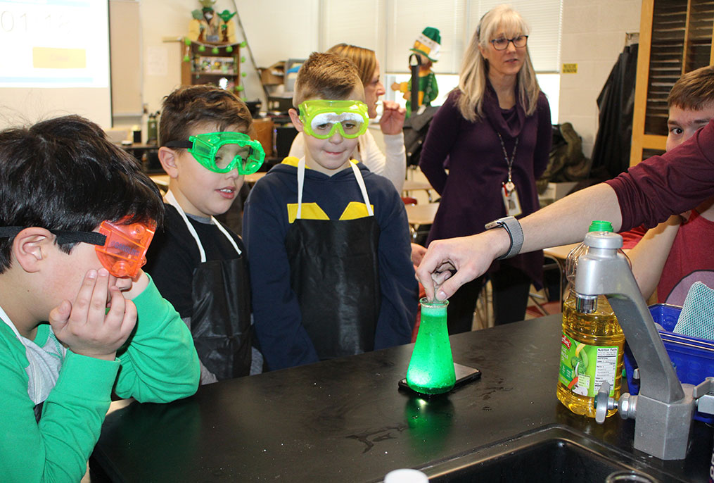 students looking at glow in the dark bubbles