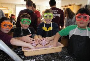 four students squeezing Oobleck