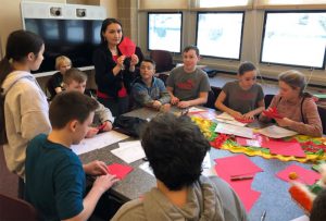 teacher demonstrating how to make a red envelope