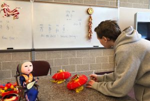 student looking at Chinese decorations