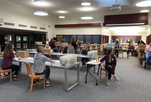 adults sitting on chairs at tables