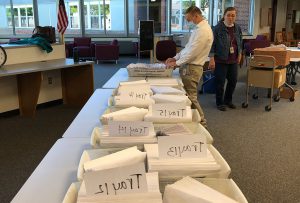 adult checking mail trays