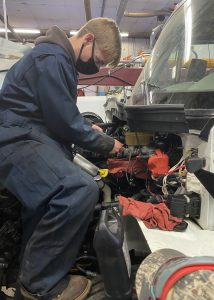 student working on vehicle