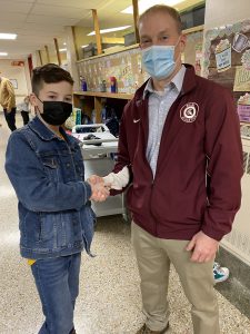 student shaking hands with Superintendent of schools