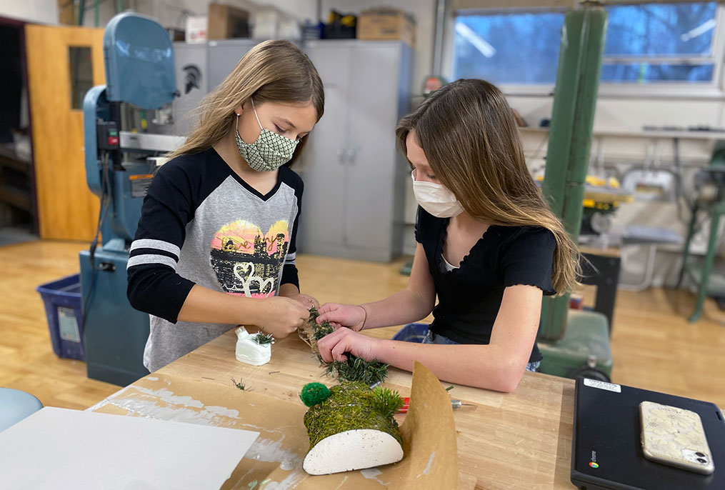 two students working on a model
