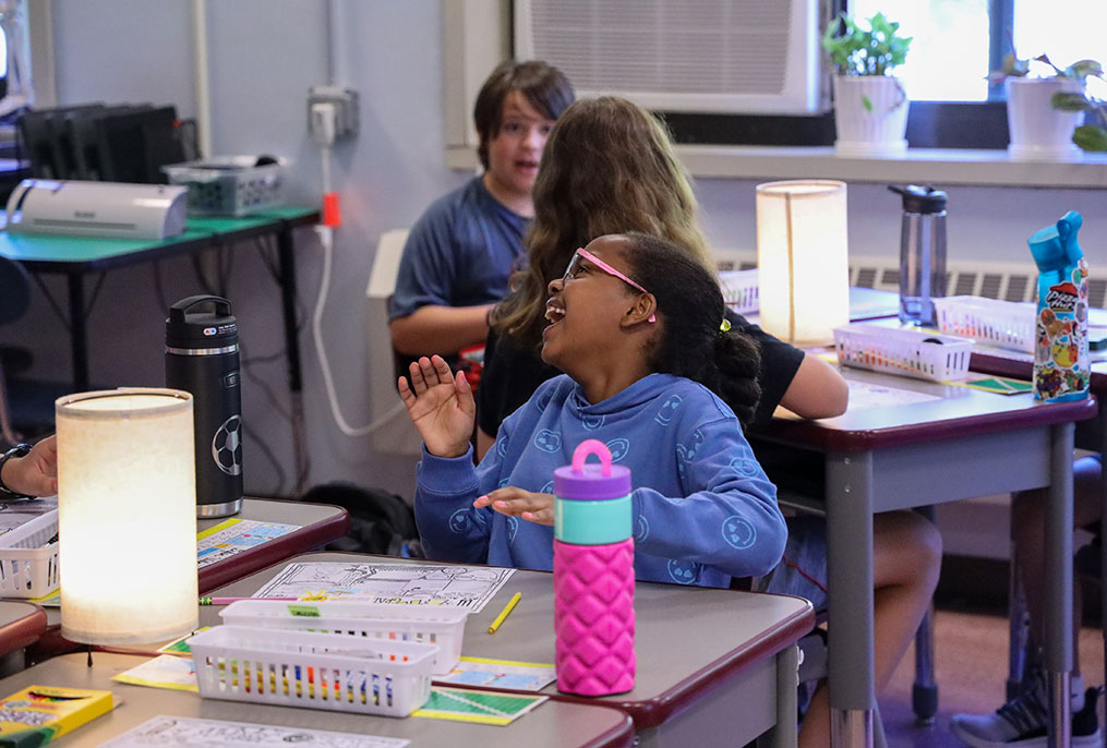 A student laughing in a classroom.