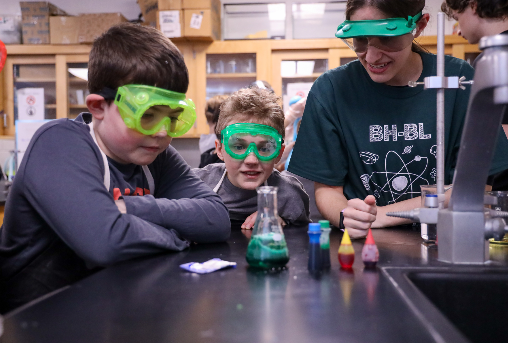 Students are watching a science experiment.