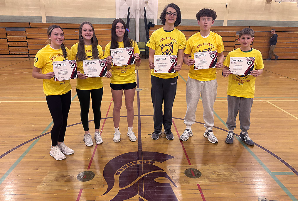 Middle School students getting an award for classwork.