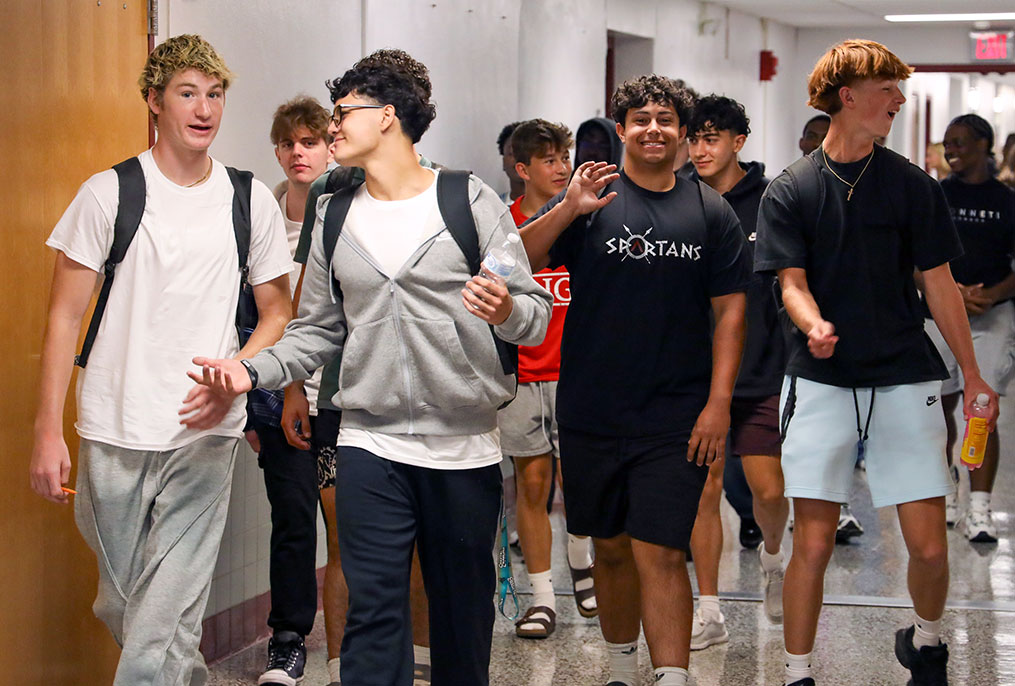 High school students walking down the hall on the first day of school.