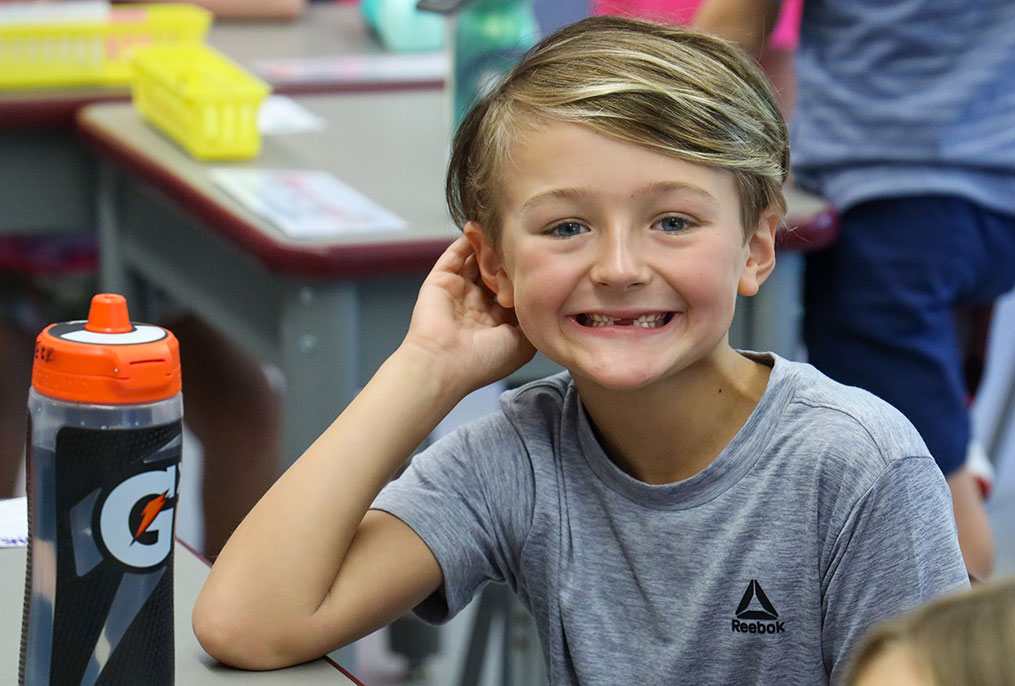 A student smiling on the first day of school.