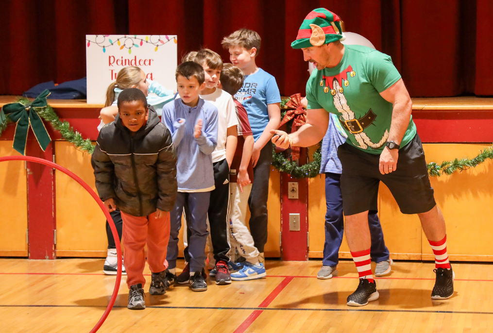 Teacher and students doing festive fun in gym class