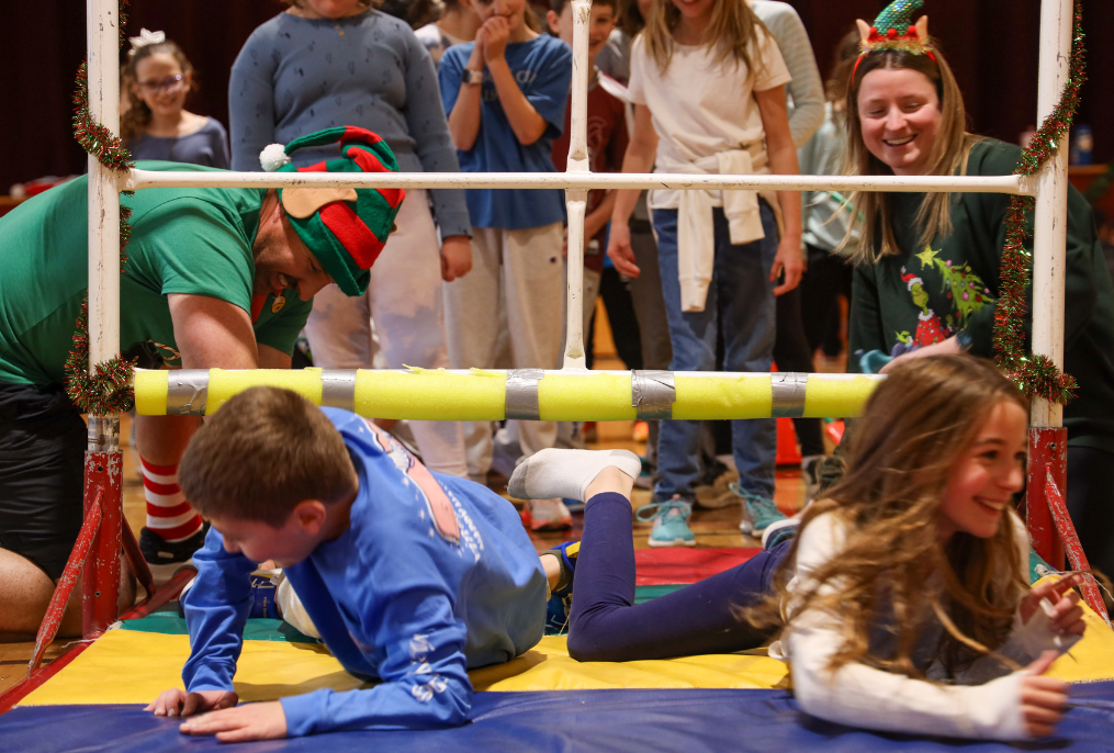 Teachers and students having fun in gym glass