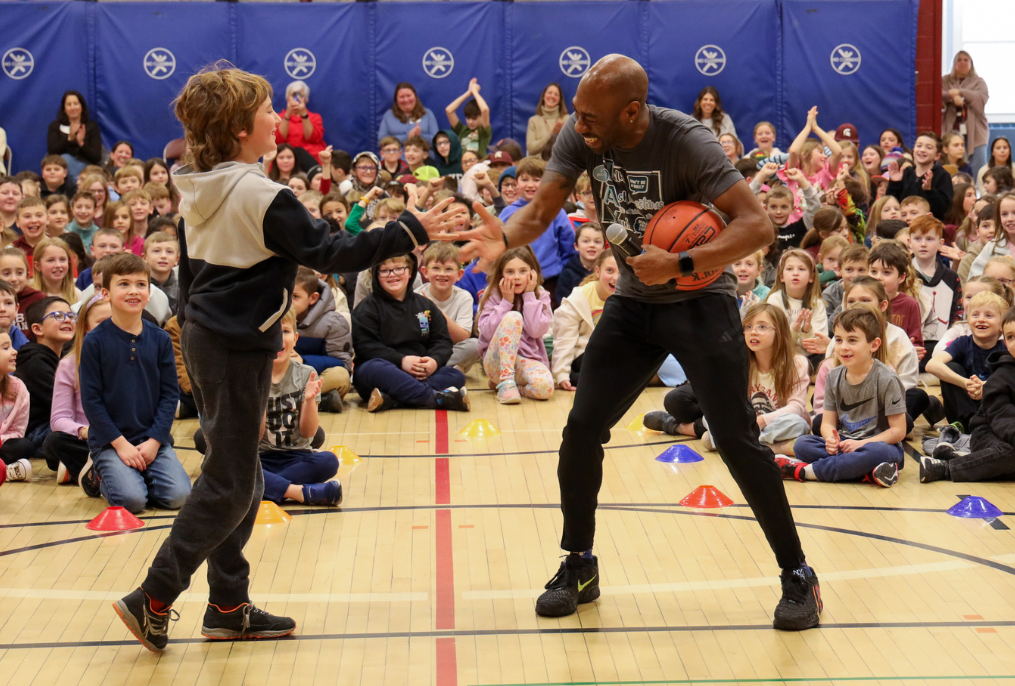Tay Fisher and a student celebrating.