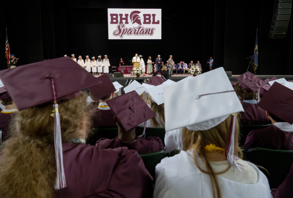 A wide shot of maroon and white caps and gowns at BHBL graduation