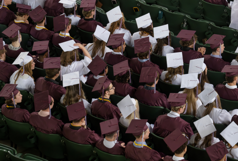 Maroon and white caps and gowns at BHBL graduation.