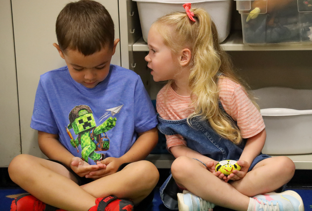 A girl talking to a boy in kindergarten class at Charlton Heights elementary school