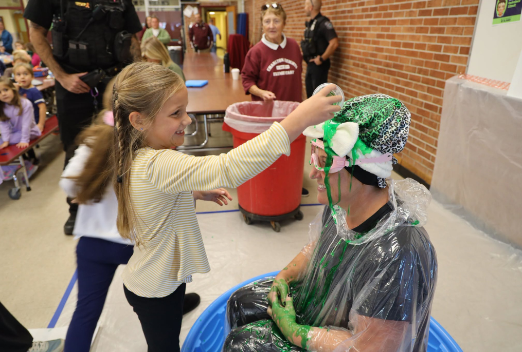 Charlton Heights student pouring slime over the principal.